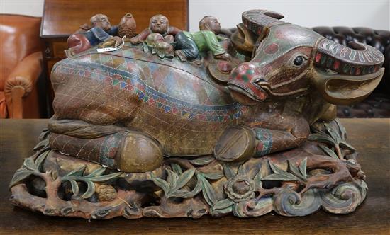 A Chinese polychrome wood buffalo on stand